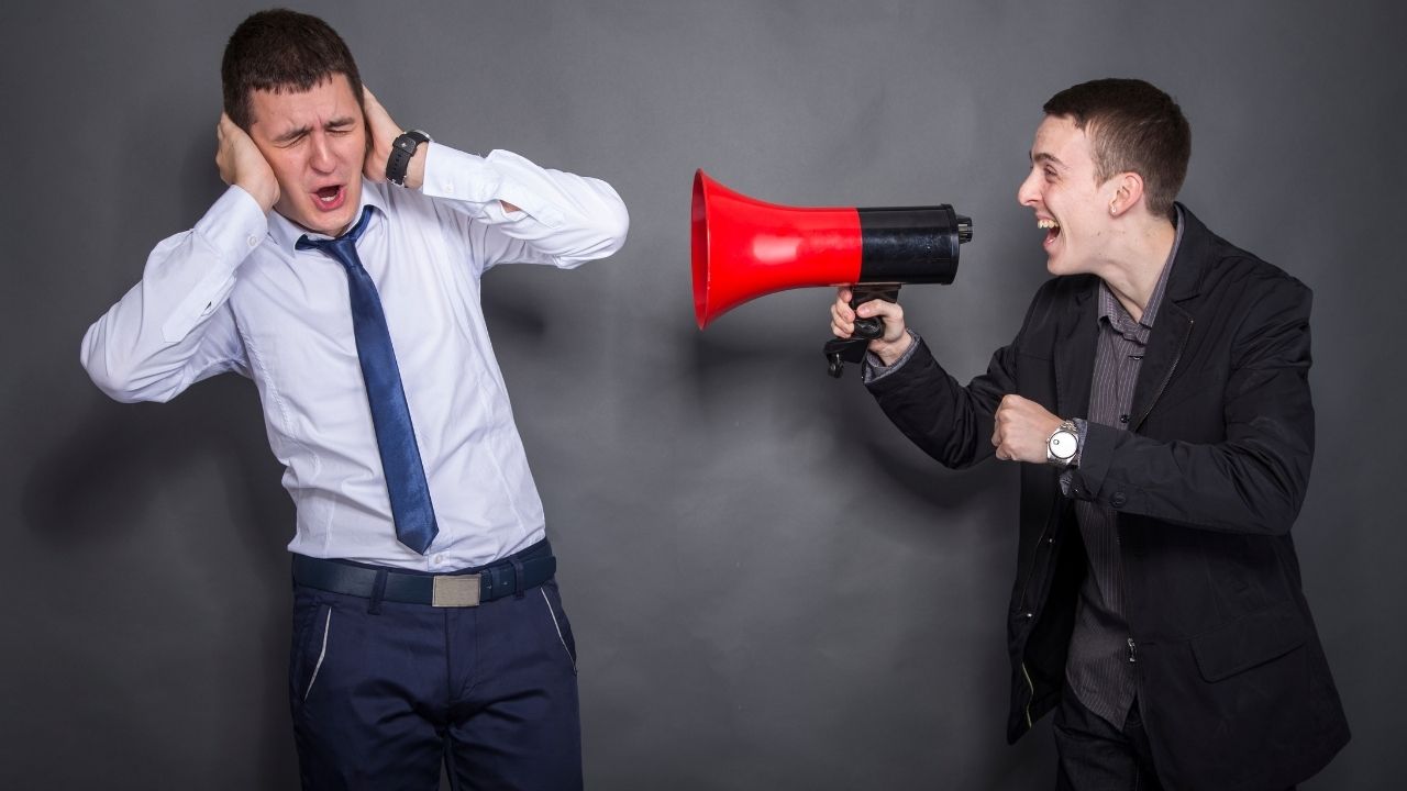 man using megaphone on another person